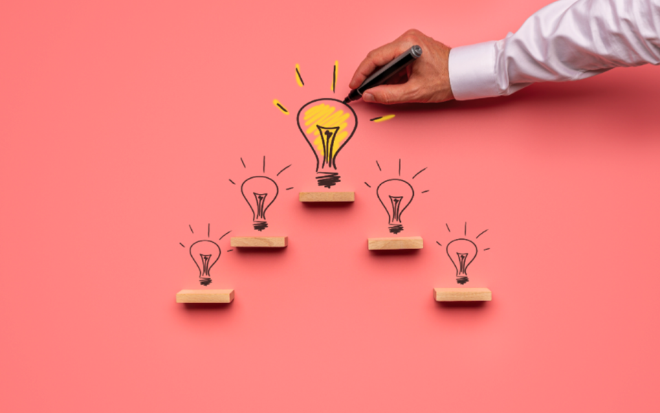 Hand drawing a yellow light bulb | Test and Buy Innovation | Digital NSW