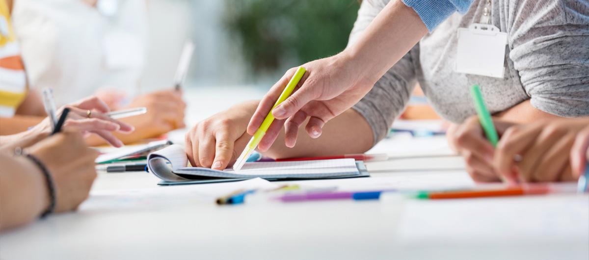 people writing with coloured pens