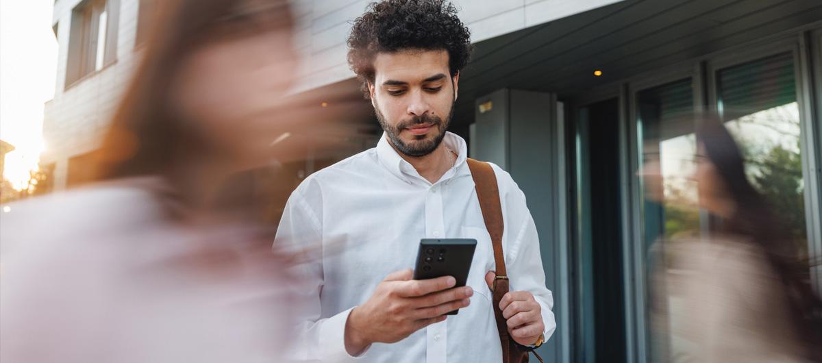 Man holding phone with moving background | NSW Digital Photo Card
