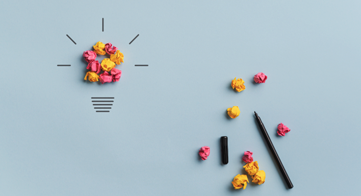 Crumpled paper forming a lightbulb with scattered pen and paper balls | Test and Buy Innovation | Digital NSW
