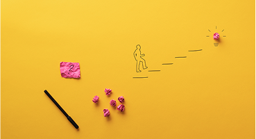 Illustration of a figure walking up steps surrounded by glowing light bulbs, a pen, and crumpled papers, symbolizing ideas and creative process | Test and Buy Innovation | Digital NSW