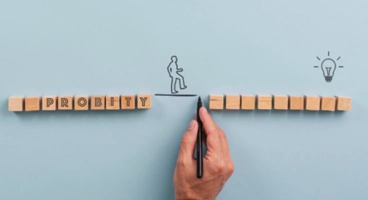 Photo of a Hand drawing a line connecting blocks spelling 'PROBITY' to a lightbulb icon, symbolizing integrity leading to innovation