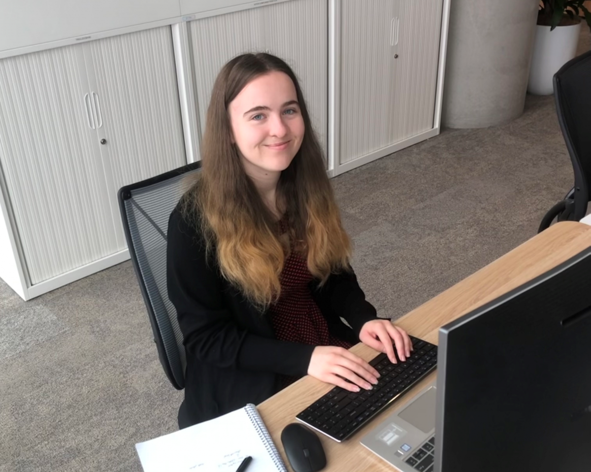 Helen typing at her desk