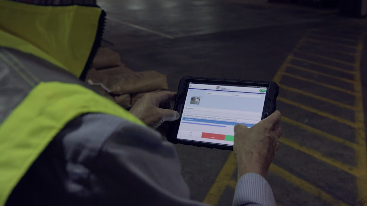 A SafeWork NSW inspector using their tablet at a worksite