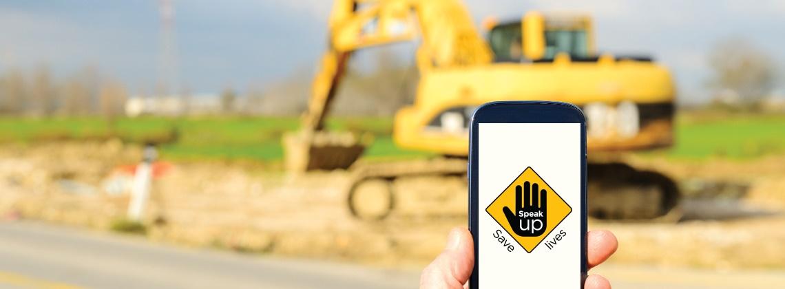 The Speak Up Save Lives app on a worksite with heavy construction machinery in the background