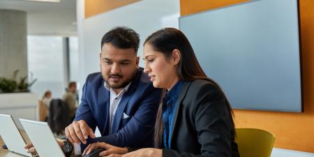 Two people looking at laptop | Digital NSW