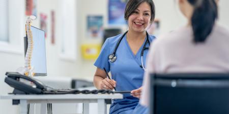 Photo of a medical staff talking to another person