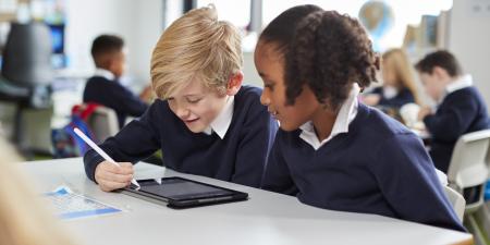 Photo of school students using a tablet device